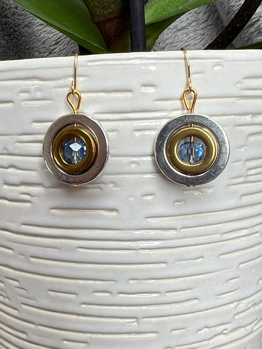 Earrings- Silver plated hoops outside gold plated hoops with blue crystal in center.