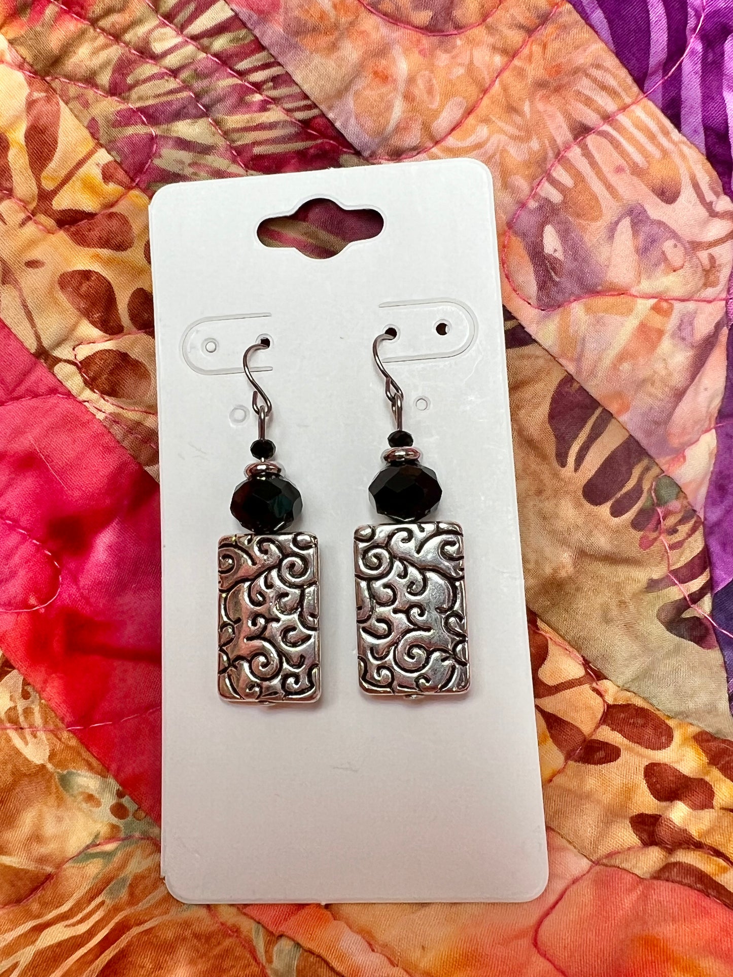 Earrings- Silver plated metal with black crystals beads.