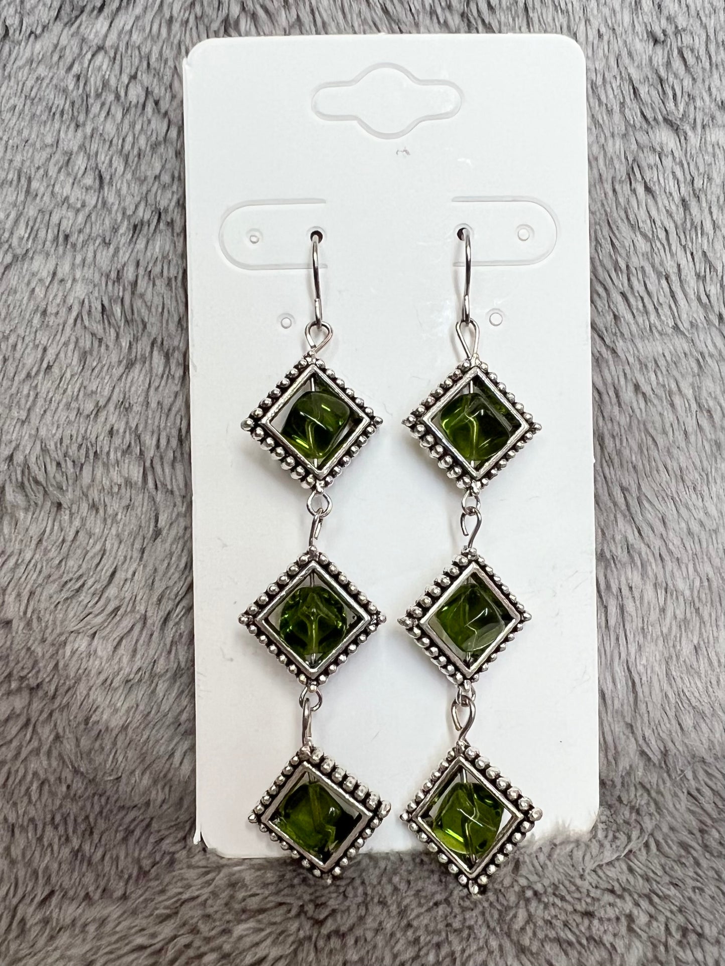 Earrings- Three tiered silver plated metal with olive colored glass beads