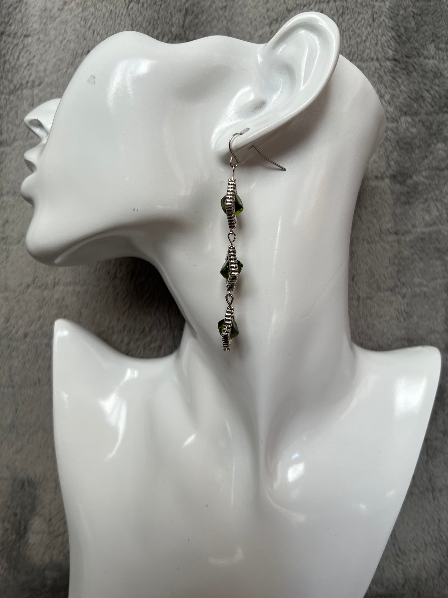 Earrings- Three tiered silver plated metal with olive colored glass beads