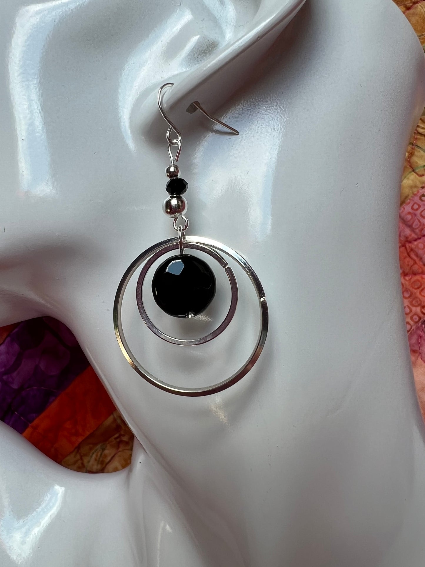 Earrings- Silver plated metal hoops with onyx coin beads.