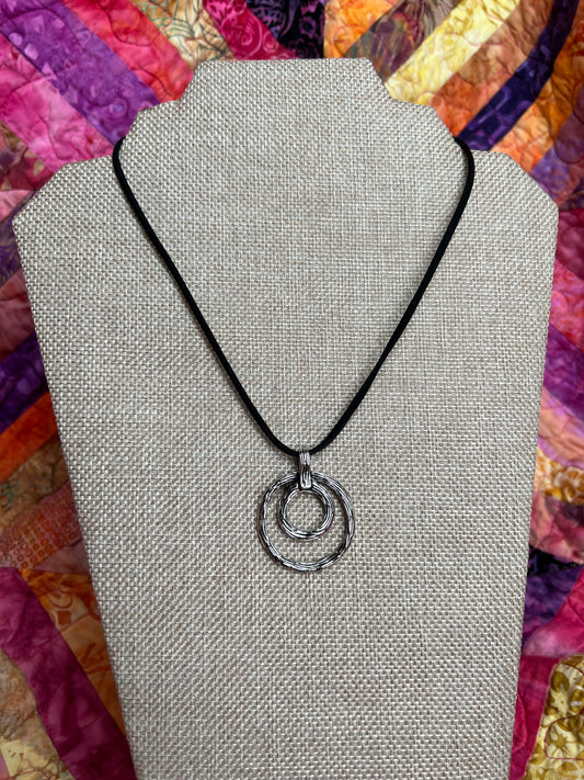 Necklace- Vegan suede cord with silver plated circle pendant.