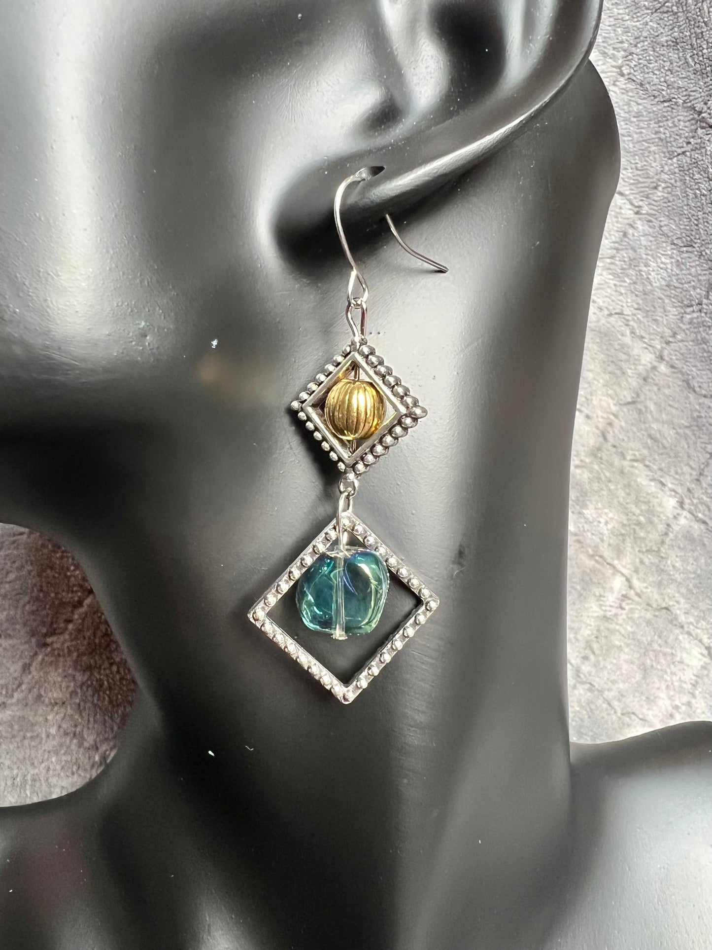 Earrings- Silver plated hooks with antique silver plated metal, round bead, and blue/green glass bead dangle.