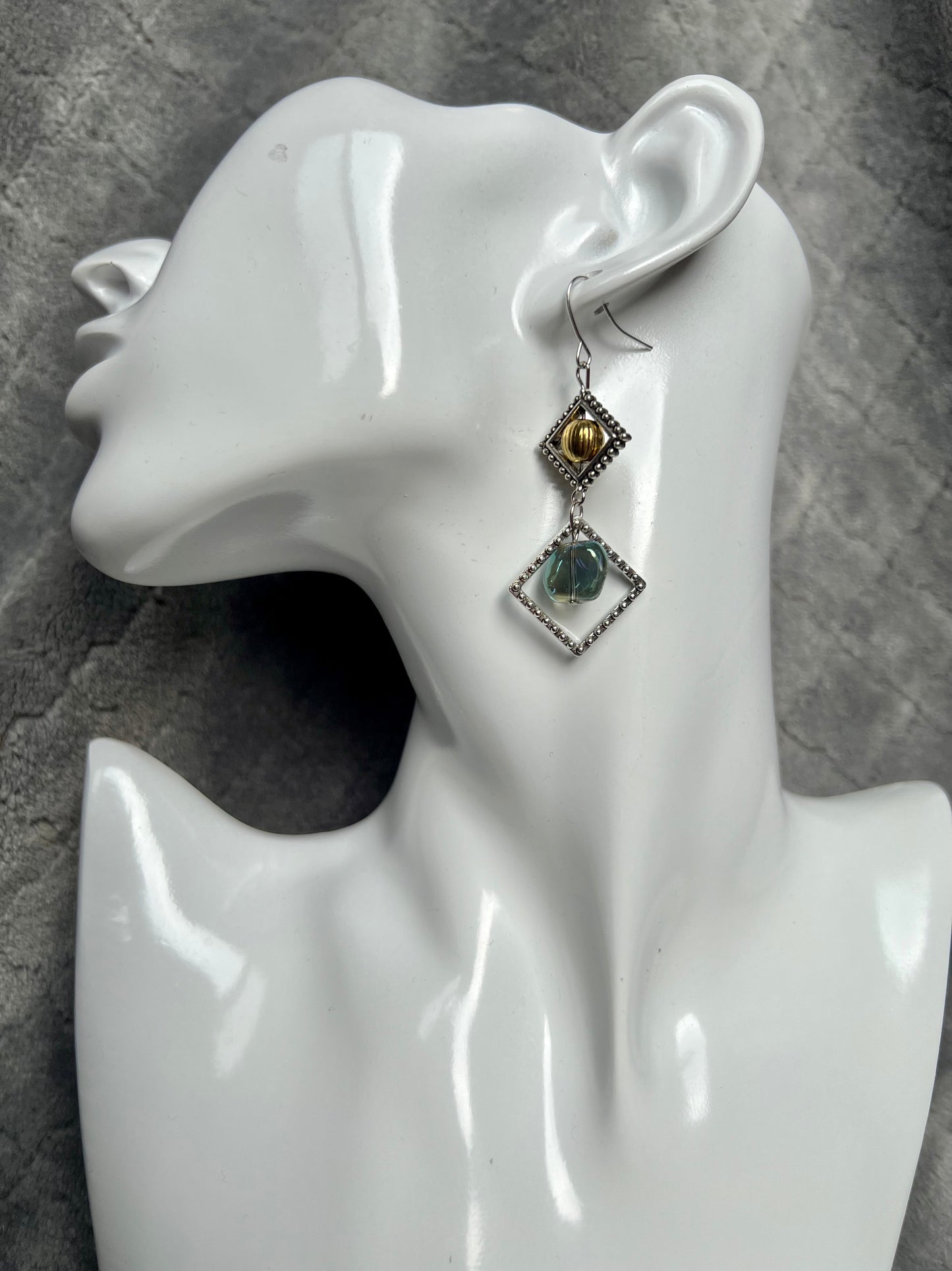 Earrings- Silver plated hooks with antique silver plated metal, round bead, and blue/green glass bead dangle.