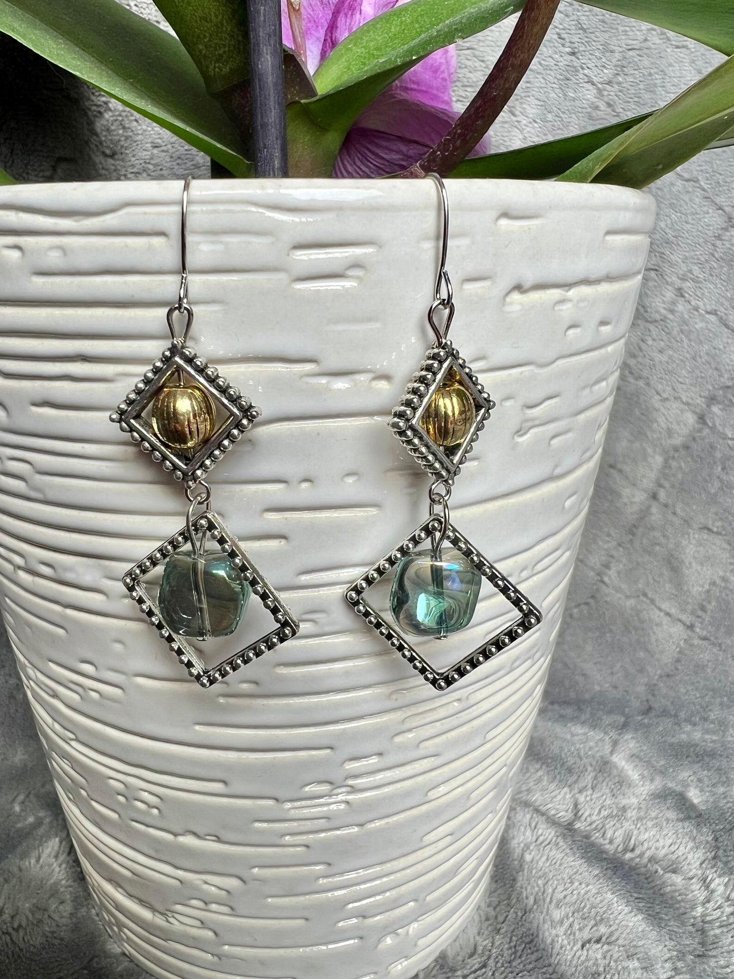 Earrings- Silver plated hooks with antique silver plated metal, round bead, and blue/green glass bead dangle.