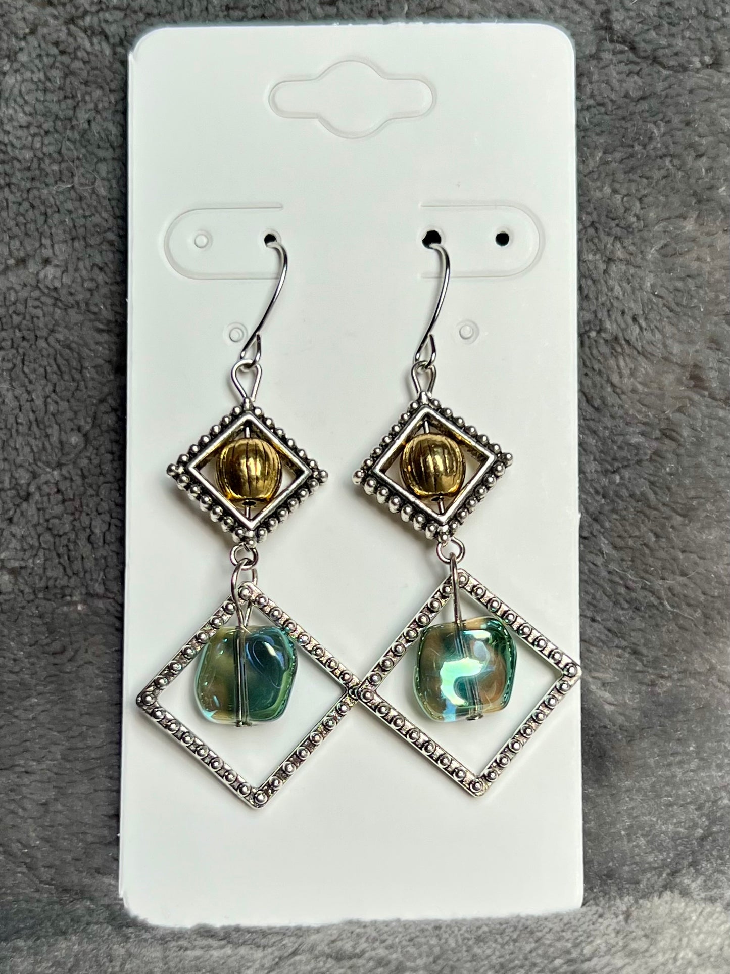 Earrings- Silver plated hooks with antique silver plated metal, round bead, and blue/green glass bead dangle.