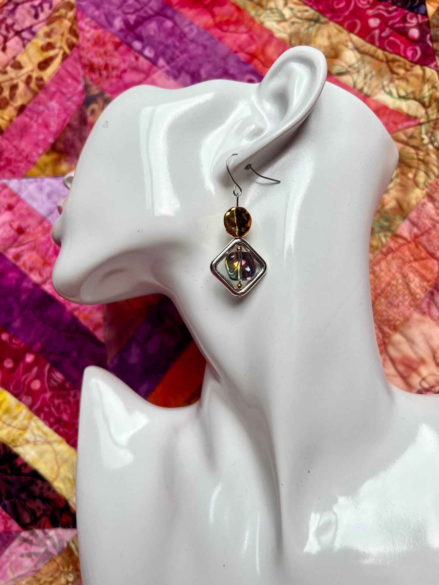 Earrings- Silver plated hooks, diamond shaped window bead, and rainbow coated pressed glass.