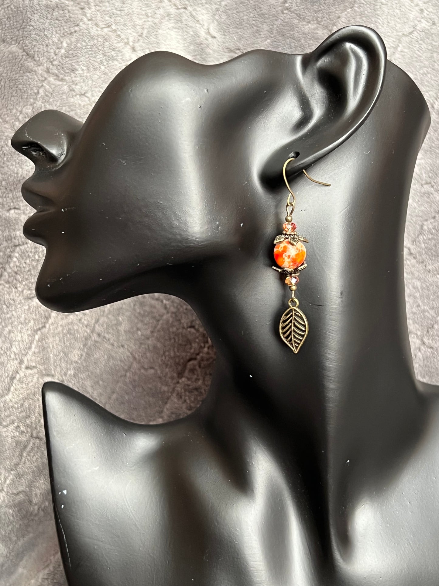 Earrings- Antique gold plated ear wires and metal leaves, small yellow orange crystal beads and natural dyed stone round beads.