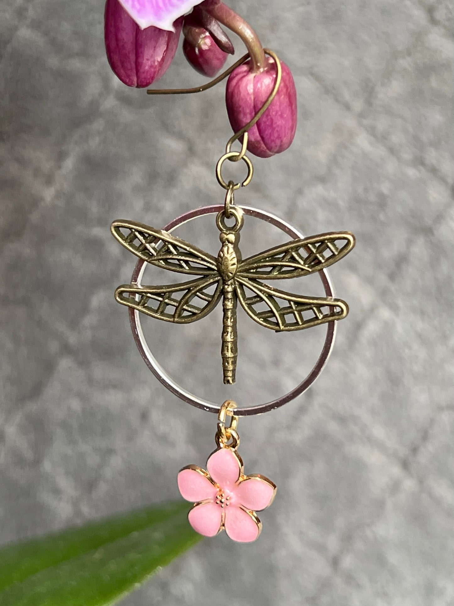 Earrings- Dragonfly earrings asymmetrical in color. Antique gold and silver dragon flies and hoops with pink flower charm.