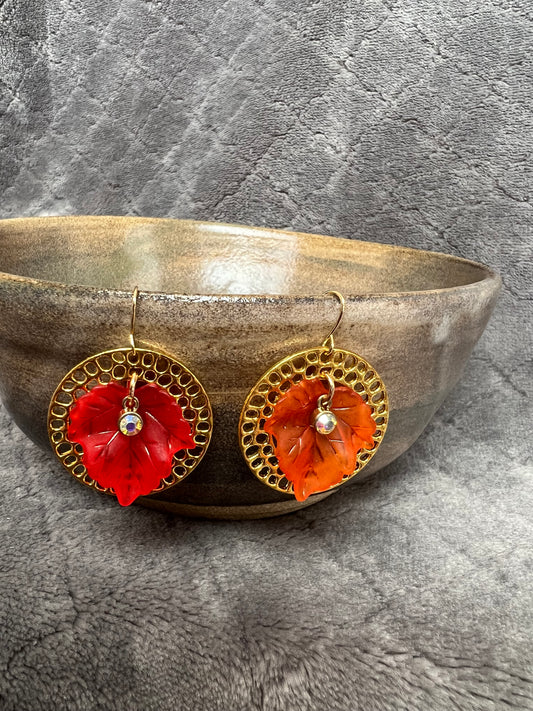 Earrings- Acrylic orange and red leaves with gold plated metal circle hoops and AB crystals.