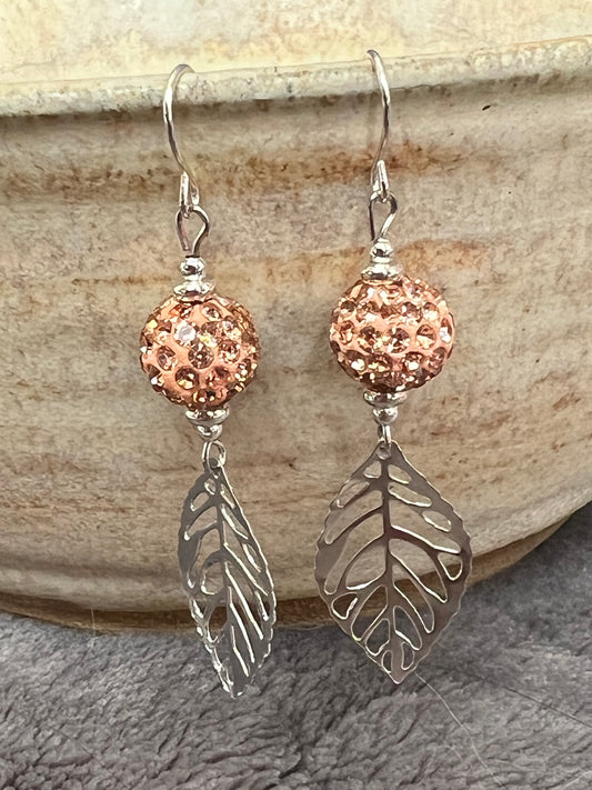 Earrings- Silver plated ear wires and metal leaves with peach colored clay and rhinestone beads.