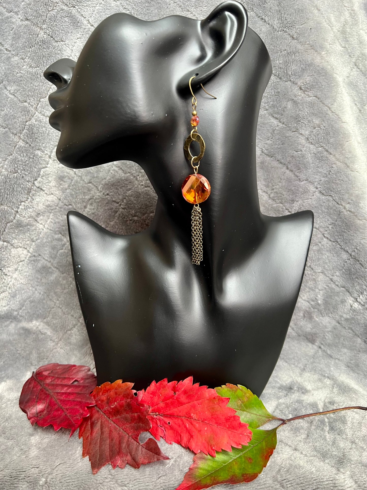 Earrings- Antique gold plated metal with orange/copper crystals with a luster coating.