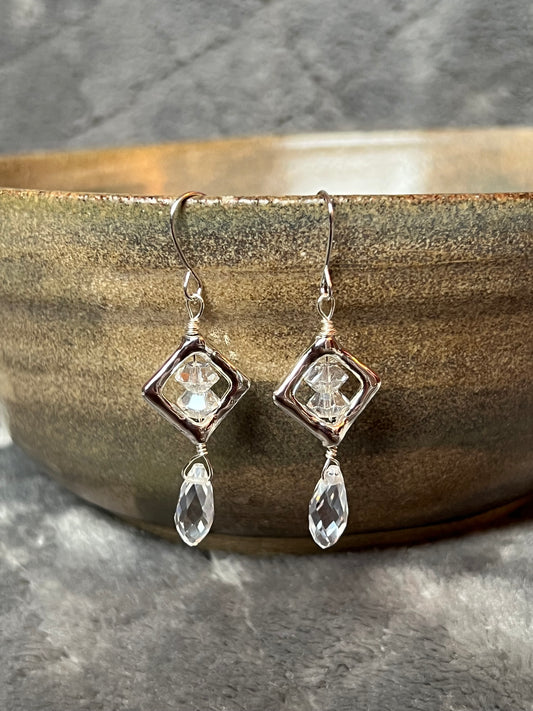 Earrings- Silver plated metal with diamond shaped bead frames and clear crystals.